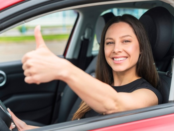 Woman Driving a Red Car