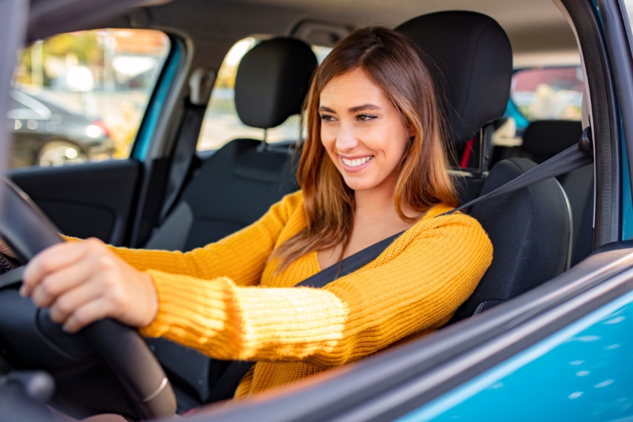 Woman Driving a Blue Car