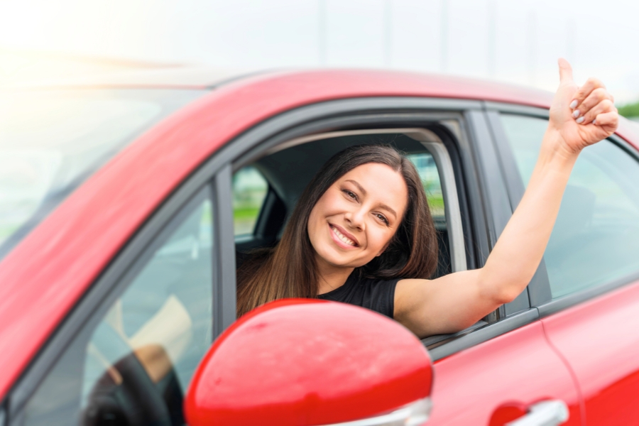 Woman Driving a Red Car