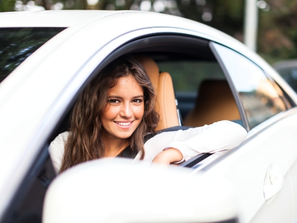 Woman Driving a White Car