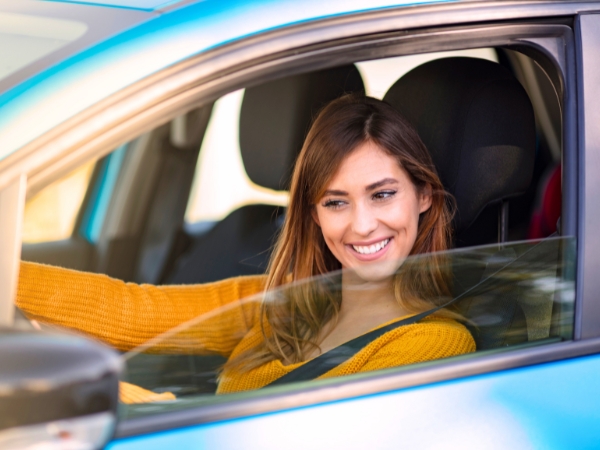 Woman Driving a Blue Car
