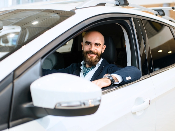 Man Driving a White Car