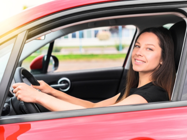 Woman Driving a Red Car