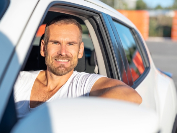 Man Driving a White Car