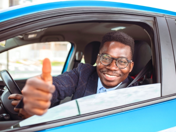 Man Driving a Blue Car