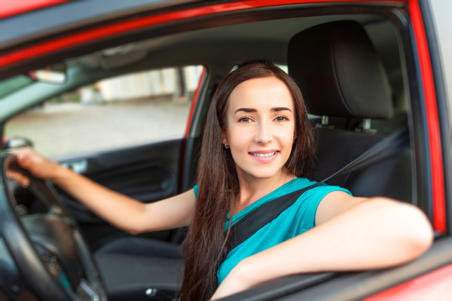 Woman Driving a Red Car